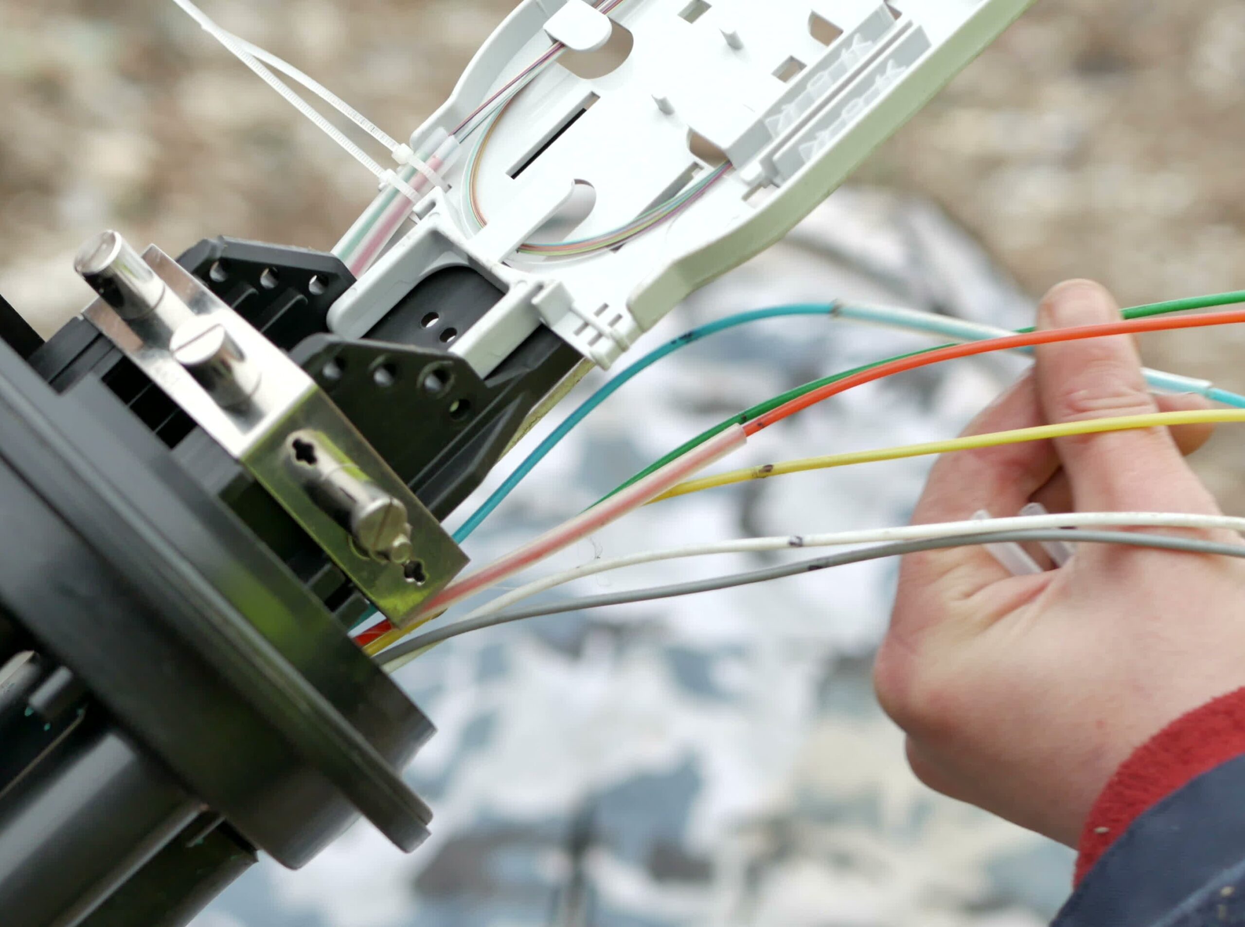 Technicians are installing optic fiber with cable ties.