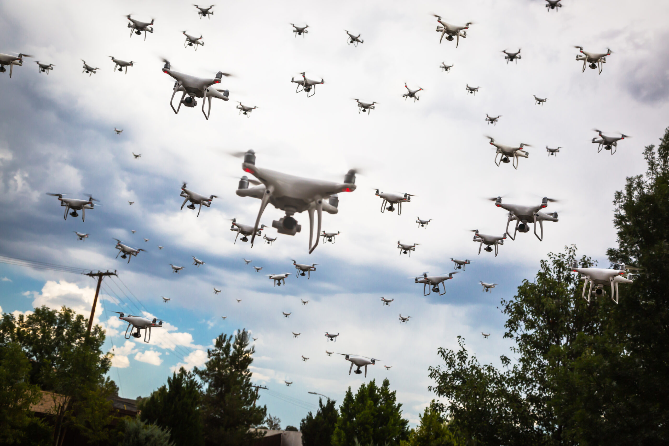 Dozens,Of,Drones,Swarm,In,The,Cloudy,Sky.